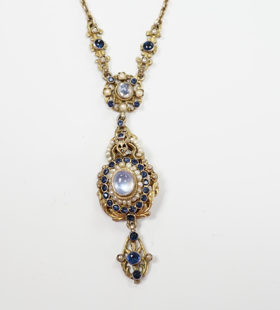 A 19th century Austro Hungarian, gilt white metal, moonstone, split pearl and gem set drop pendant necklace, overall 56cm.